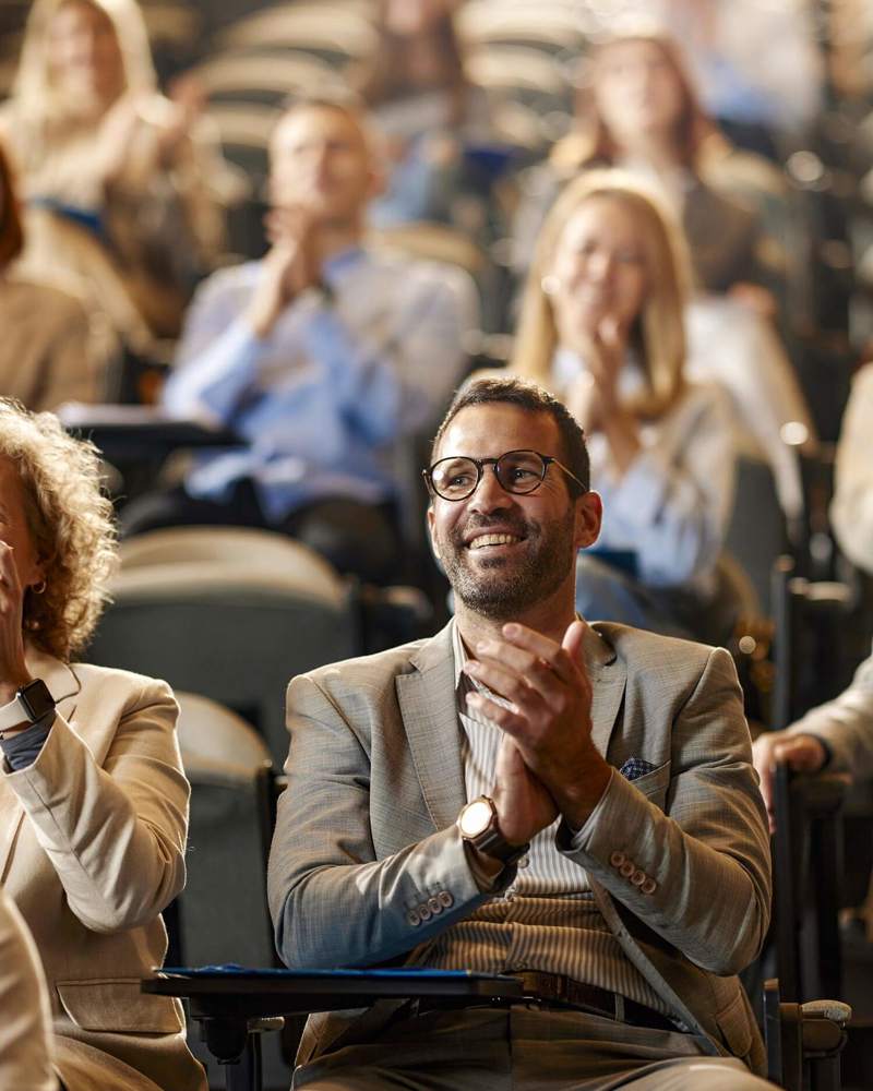 a man smiles and applauds