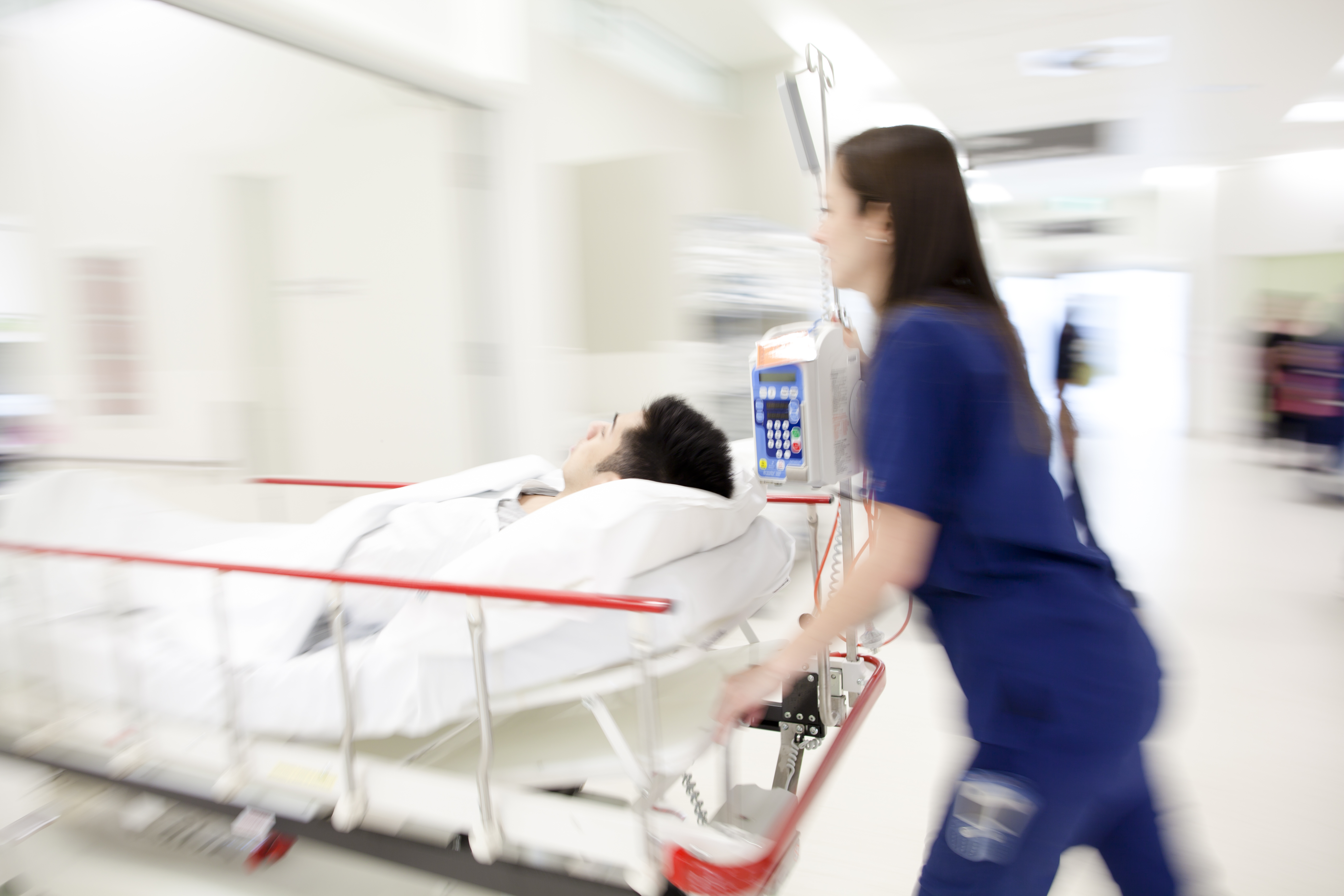 a nurse pushing a patient in a gurney