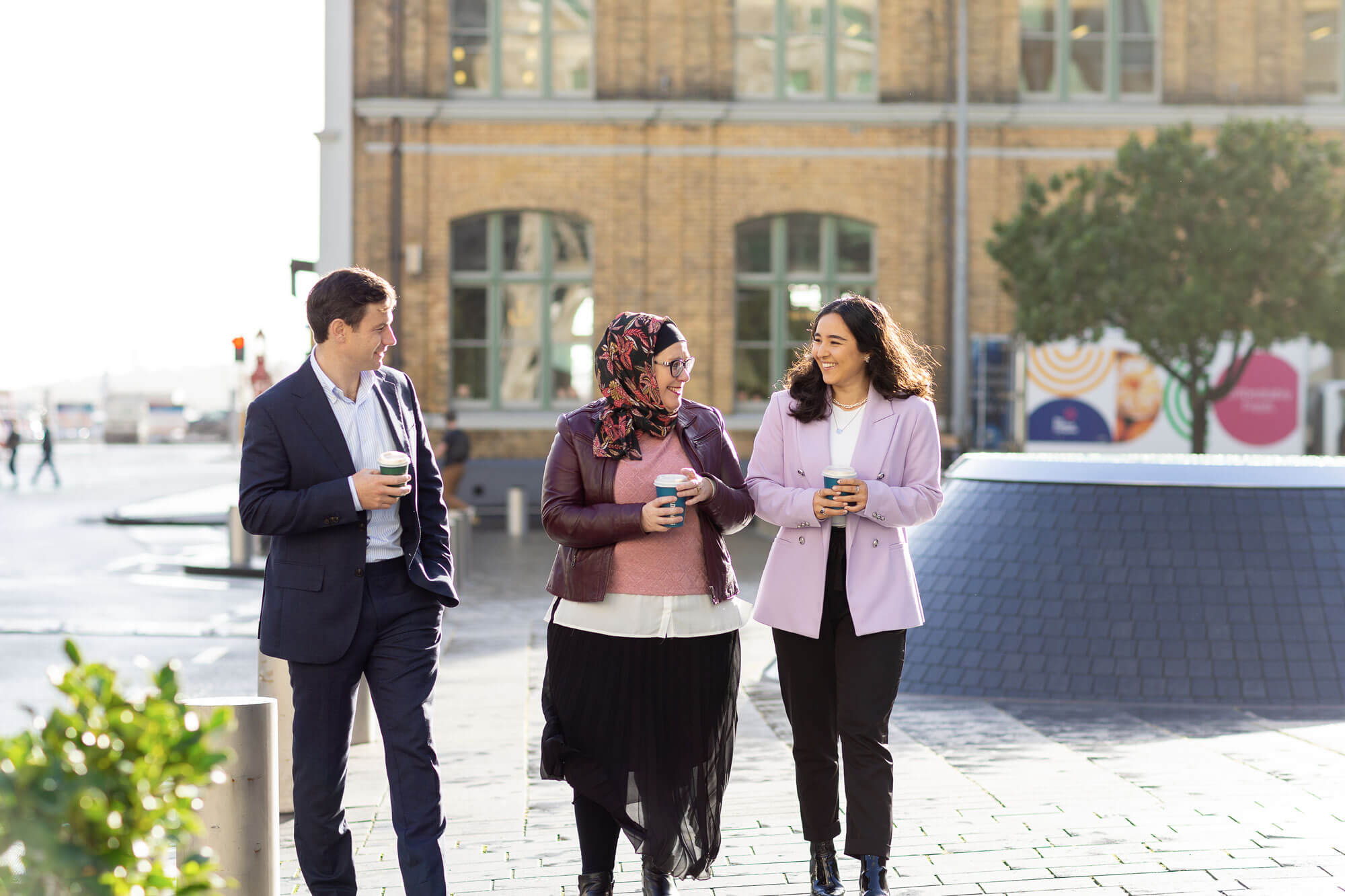 Three legal professionals walking on the street