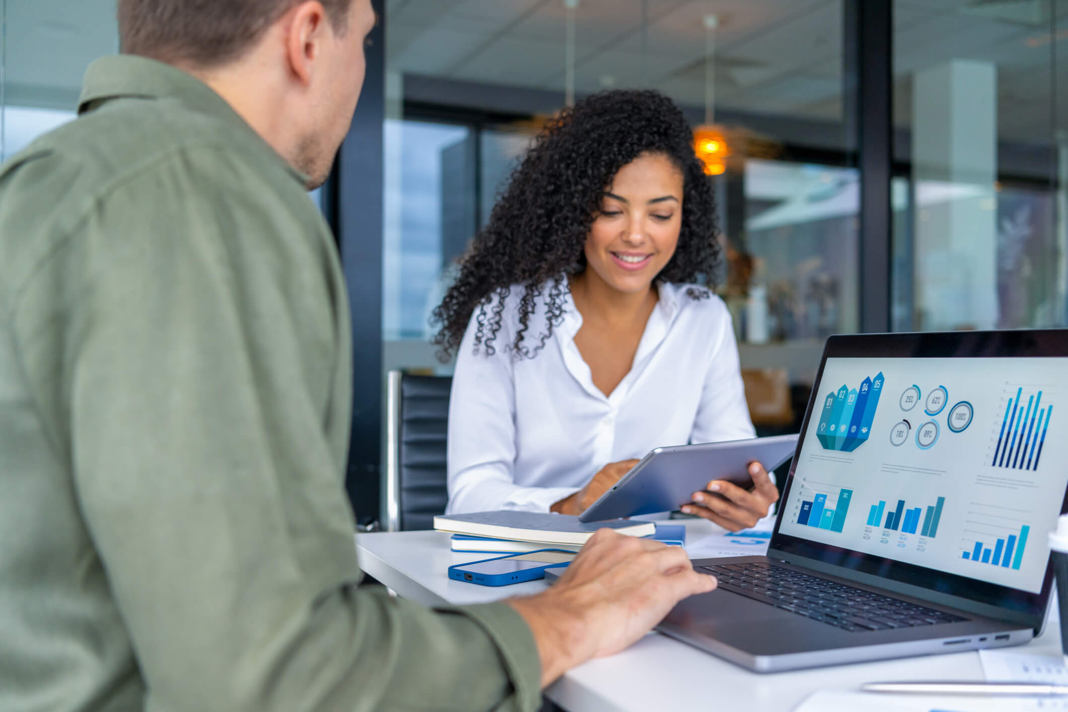 a man and a woman discuss in a meeting