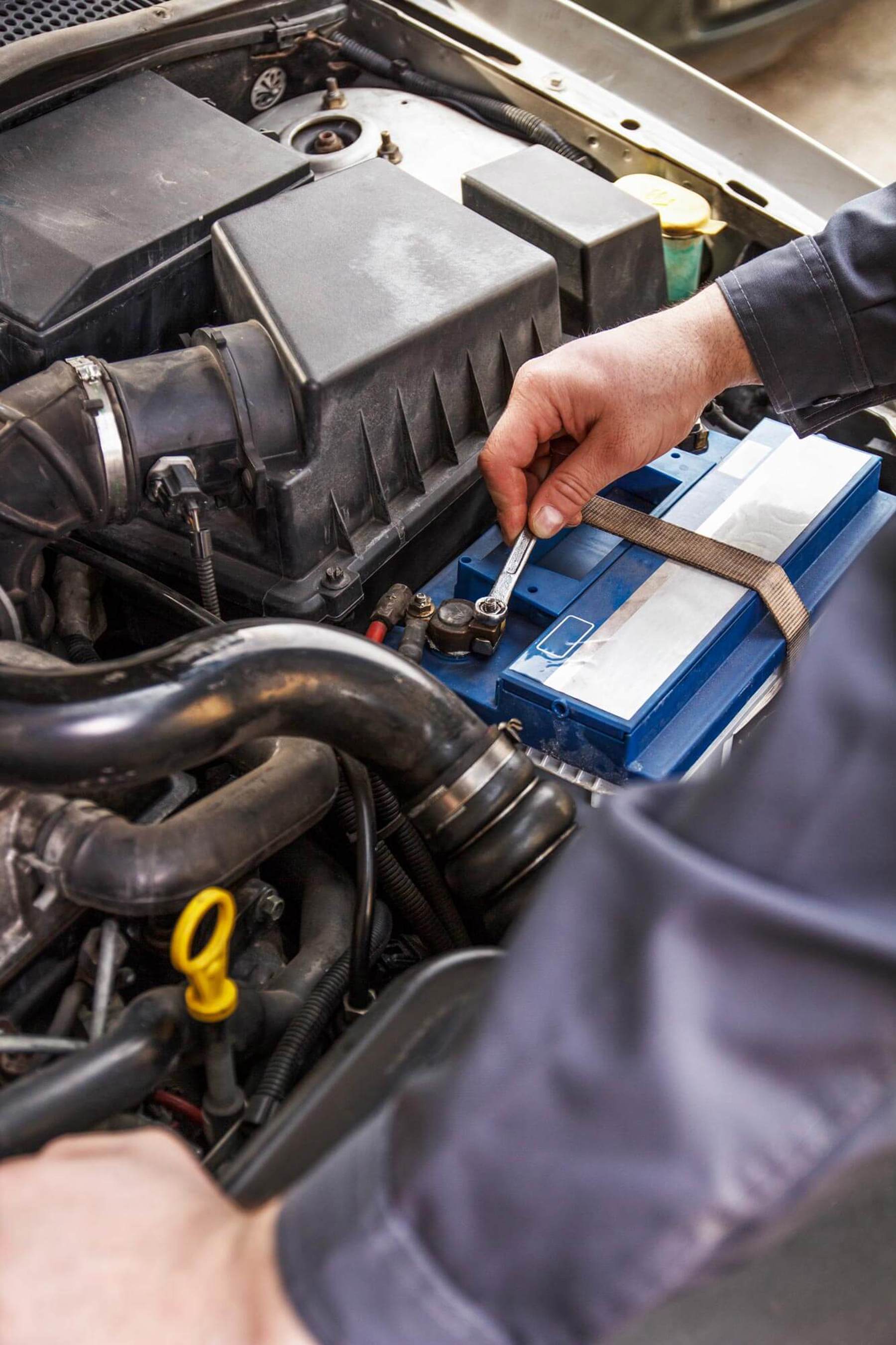 Mechanic fixing car battery